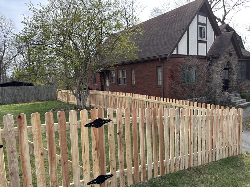 Custom wood picket fence along a front yard